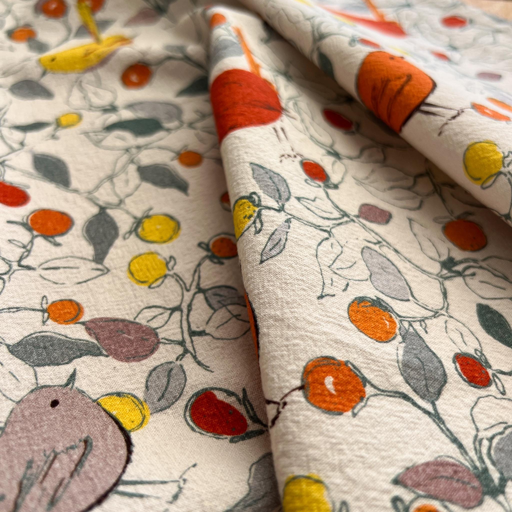 Close-up of fabric with colorful floral and bird pattern