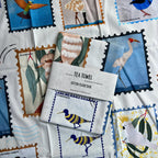 Australian birds tea towel featuring colourful native bird illustrations such as brogla, spoonbill, rainbow bee-eater, fairy wren, cockatoo, kookaburra.