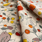 Close-up of fabric with colorful floral and bird pattern 