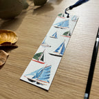 Bookmark with watercolour sailboat design on a wooden surface