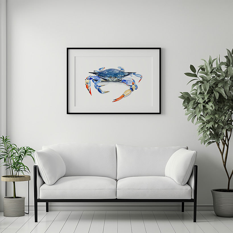 White sofa in a living room with a framed picture of a blue crab on the wall.