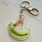 Keychain with a bush stone curlew design on a green and white background