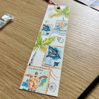 Bookmark with tropical designs on a wooden surface