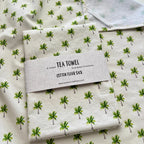 Tea towel with palm tree pattern made of soft cotton fabric.