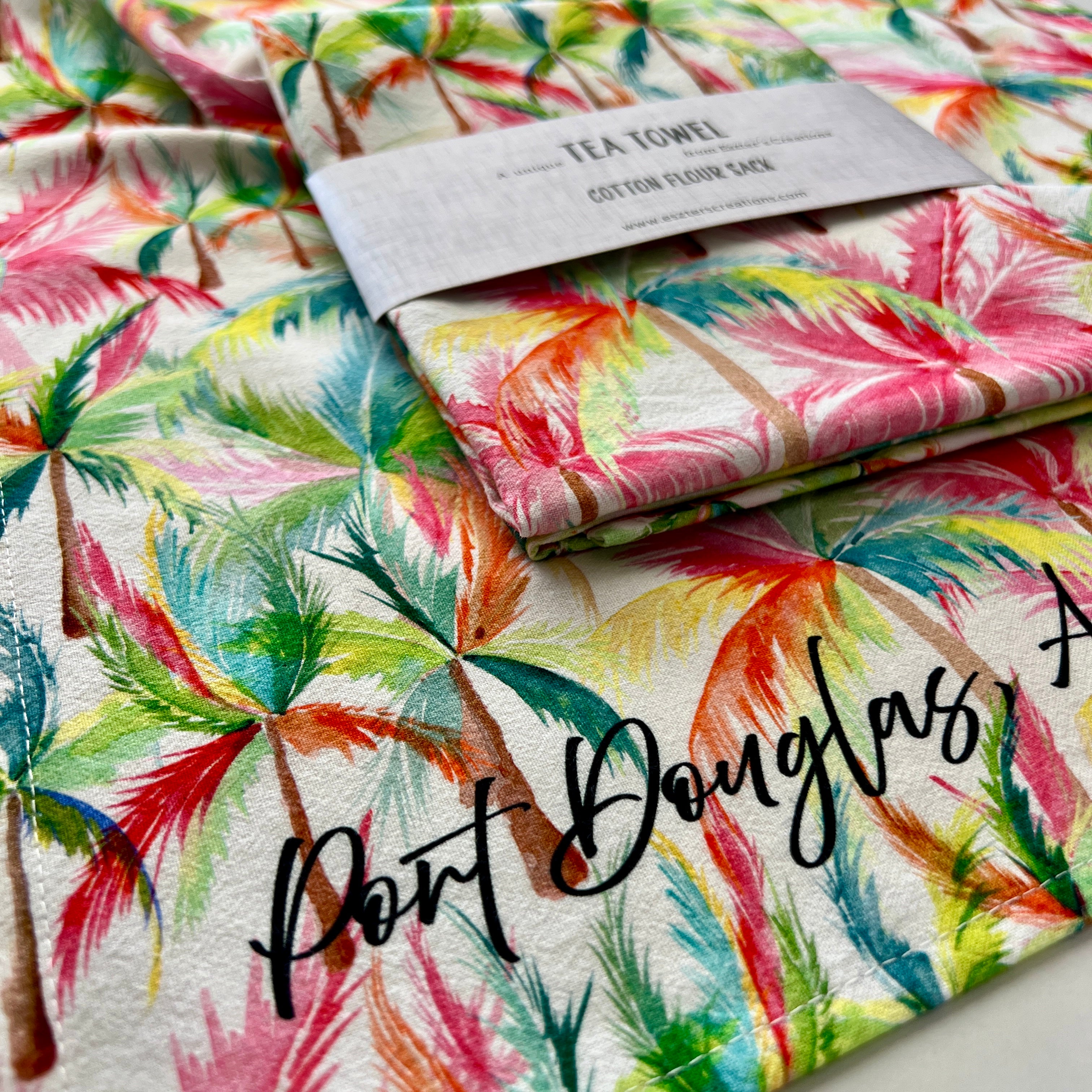 Colorful palm leaf patterned cotton teatowel with with 'Port Douglas' text.