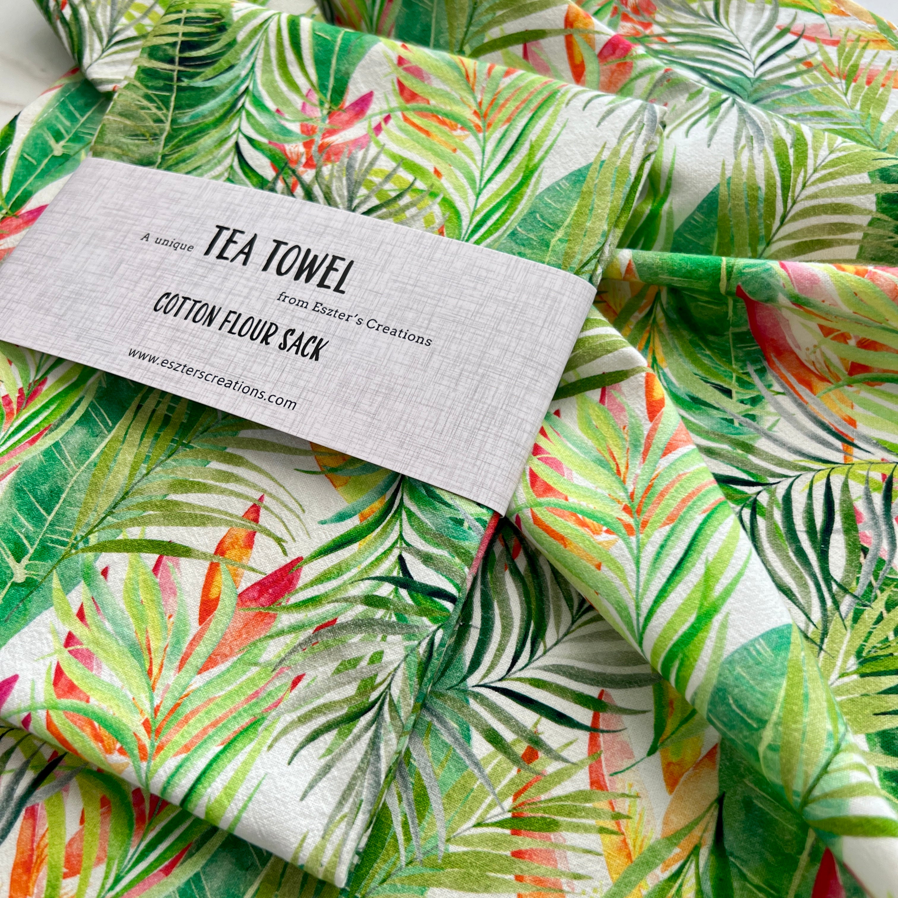 Soft cotton teatowel featuring watercolor tropical leaves and heliconia flowers painted by Eszter Torok. 