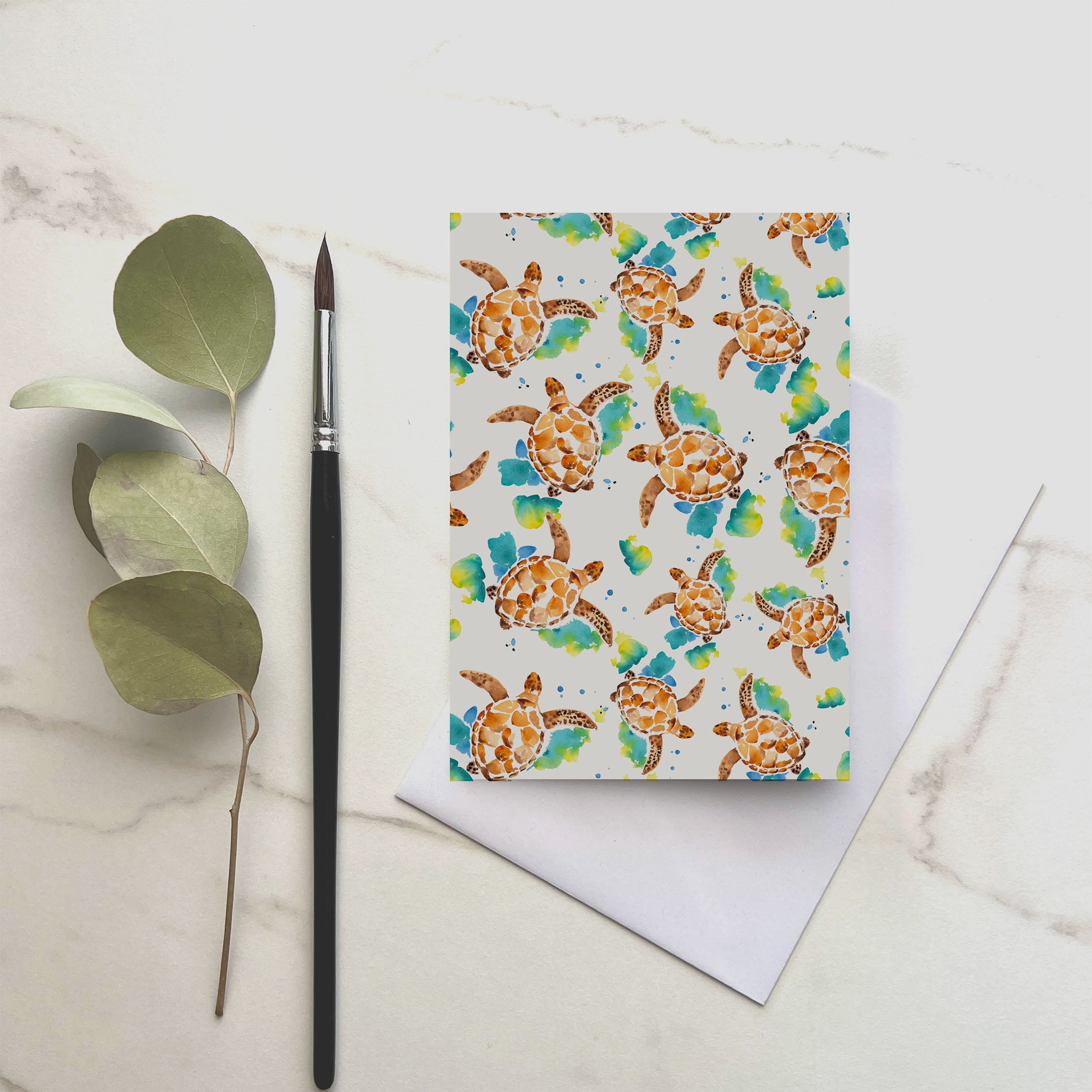 watercolour green turtle greeting card with brush and eucalyptus leaf 