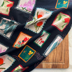 wildflower postage stamp design on black tea towel by Eszter Torok